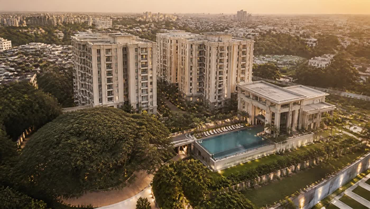 Aerial view of an Aarav Estates residential development at golden hour